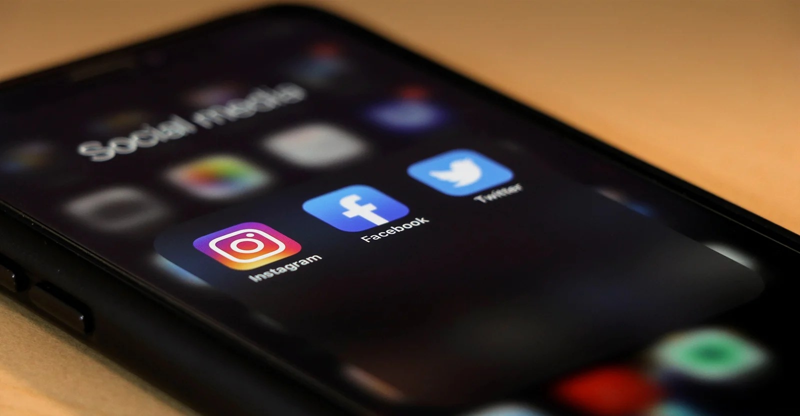 Phone with social media icons including facebook and instagram