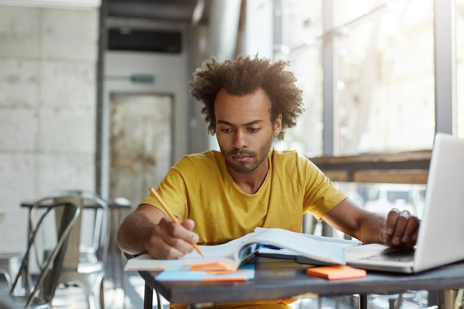 male-student-writing
