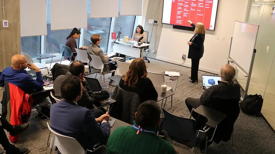 Events and outreach seminar speaker presenting while audience watches and listens